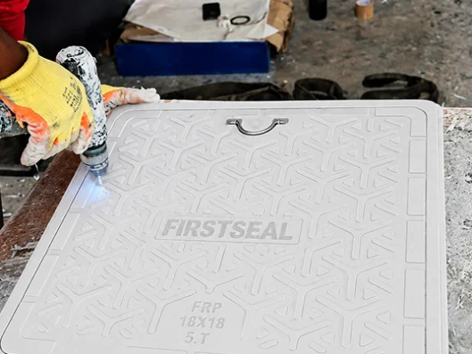 FRP manhole cover production by hydraulic compression molding at FirstSeal Prime